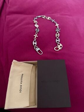 Louis Vuitton Silver Logo Charm Chain Belt on Pink Background